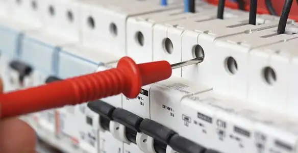 Electrical contractor testing circuit breakers during electrical repair in Gilbert, AZ