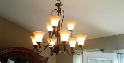 Classic ceiling chandelier installation with warm lighting in Scottsdale, AZ