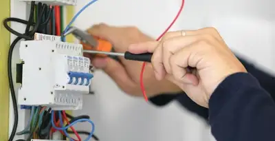 Electrician installing and adjusting circuit breakers in an electrical panel in Scottsdale, AZ