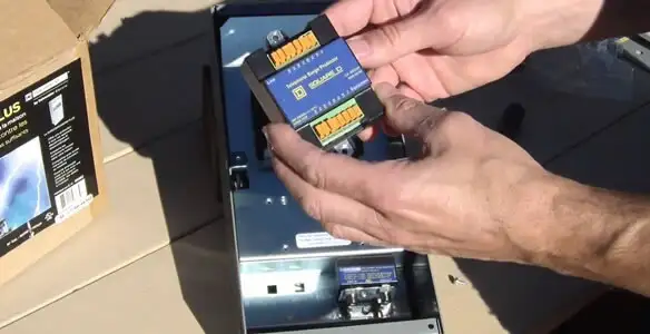 Electrician installing whole home surge protection unit inside main electrical panel in Scottsdale, AZ