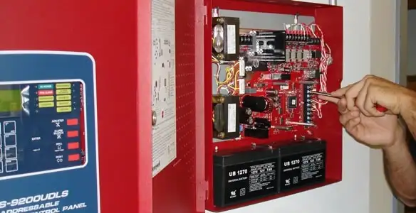 fire alarm installation service showing technician configuring fire alarm control panel in Scottsdale, AZ