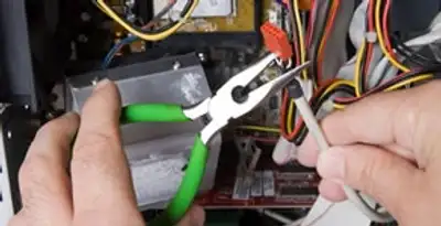 Licensed electrical contractor performing electrical repair with tools in Mesa, AZ