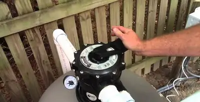 pool pumps service showing professional adjustment of pool pump control system in Scottsdale, AZ