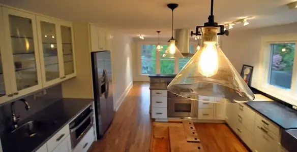 Residential electrician installing modern indoor light fixture in a home in Scottsdale, AZ